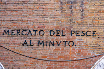 Italian City of Venice with close-up of lettering at fish market hall on a cloudy summer day. Photo taken August 6th, 2023, Venice, Italy.