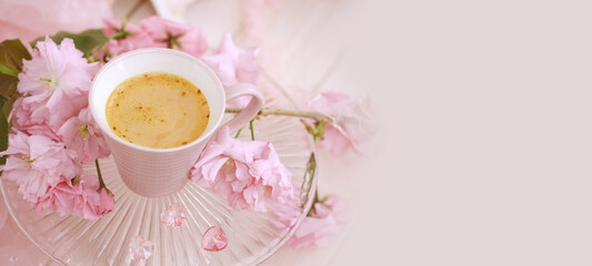 cup with drink coffee cappuccino, hot chocolate with milk, sakura flowers, caffeine improves...