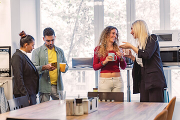 Business people talking while relaxing during the coffee break in the office. Business concept.