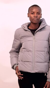 Confident diverse female friends in jackets over white background