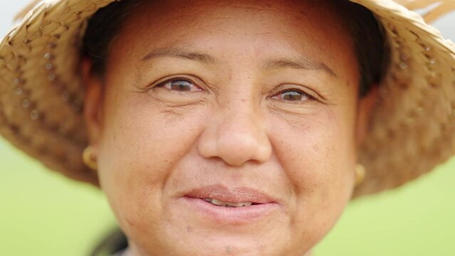 Closeup, middle-aged asian woman with genuine, authentic, and radiant smile