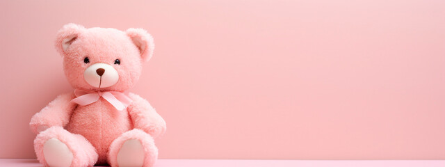 Obraz premium Pink teddy bear on a pink background. Selective focus.