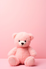 Pink teddy bear on a pink background. Selective focus.