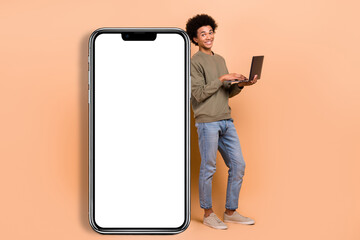 Full body photo of young man it coder hold netbook development new application smartphone display...