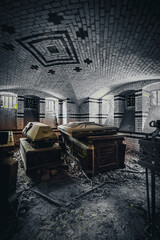 The abandoned mausoleum with open coffins