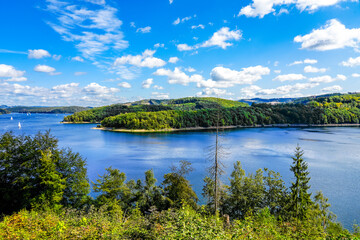 Fototapeta na wymiar View of the Biggesee near Attendorn in the Olpe district with the surrounding nature. Landscape by the lake in the Sauerland. Bigge Dam. 