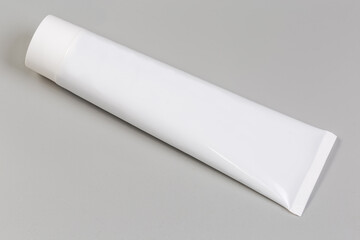 White plastic tube of toothpaste or other hygiene care product