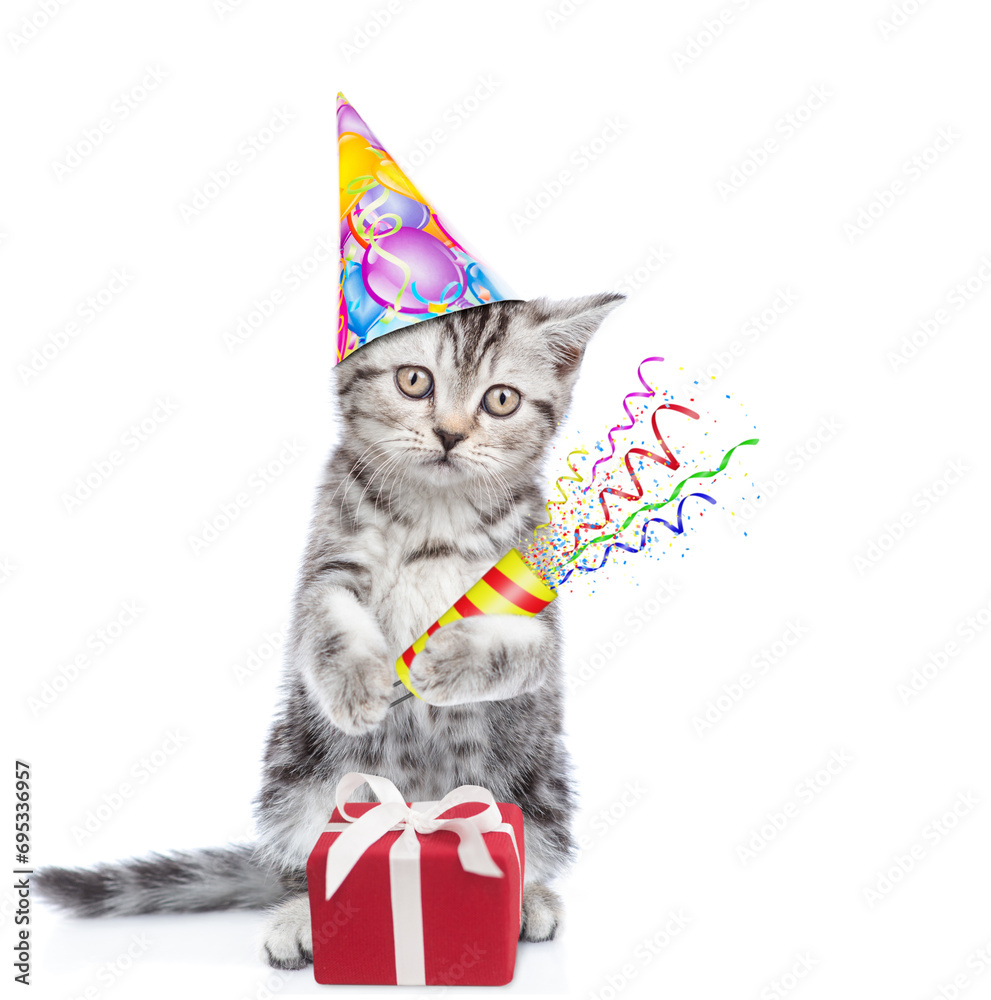 Poster Cute kitten wearing sunglasses and party cap holds exploding firecracker. Isolated on blue background