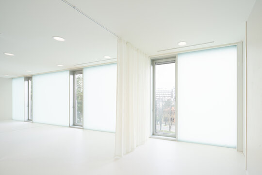 White room with glass windows and curtain in hospital