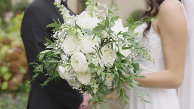 Bride Holding Beautiful White Flower Bouquet While Standing With Groom