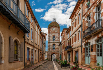 Medieval village of Auvillar and its clock tower, in Tarn et Garonne, Occitanie, France - 695337994