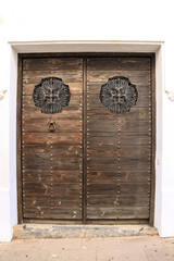 Old wooden door with wrought iron details