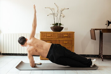 Man doing rehab exercise on mat at home
