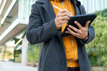 Business professional using tablet outdoors