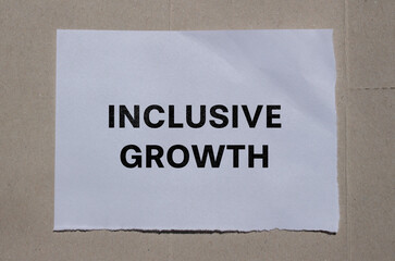 Inclusive growth lettering on ripped paper. Business concept photo.