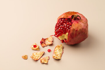 Peeled pomegranate on a light background. Fresh pomegranate