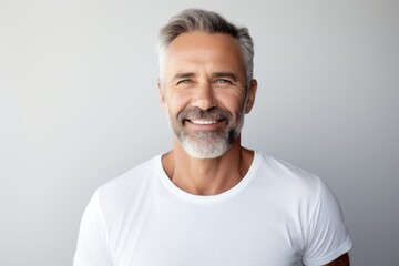 Portrait of a grinning man in his 50s donning a trendy cropped top against a white background. AI Generation