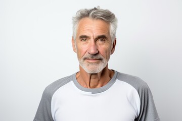 Obraz premium Portrait of a content man in his 60s sporting a breathable mesh jersey against a white background. AI Generation