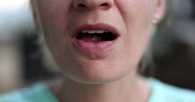 Closeup of beautiful teeth female mouth eating walnuts. Walnut medicinal properties