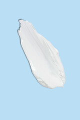 Liquid cream cosmetic smudge drops texture on blue background. cosmetic smears cream texture. skin care product stroke flat lay, cream with hyaluronic acid.