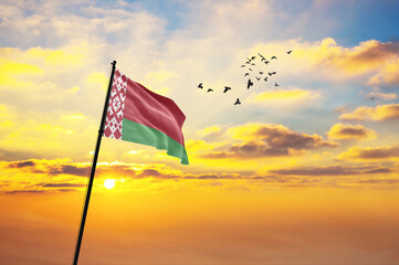 Waving flag of Belarus against the background of a sunset or sunrise. Belarus flag for Independence...