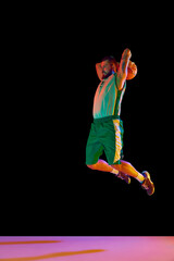Powerful moment frozen in time, basketball player commitment to perfect slam dunk against black...