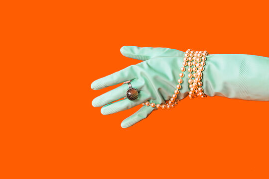 Elegant accessory on mint glove against orange backdrop - Powered by Adobe