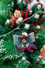 part of Christmas tree with decorations close up at vertical composition