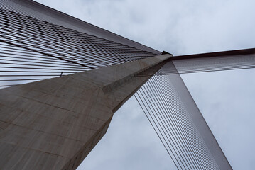 Modern suspension bridge design against cloudy backdrop