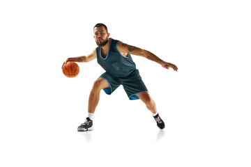 Dynamic portrait of professional basketball player, fit man honing skills with precision dribbling against white background.