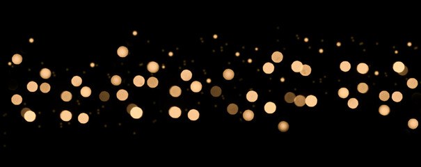 Bokeh. Blurred abstract lights with yellow tones on black background. Defocused Lights and Dust...