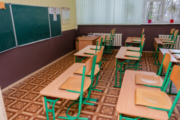 Furniture at school. Empty class. Wooden desks with chair. Double table