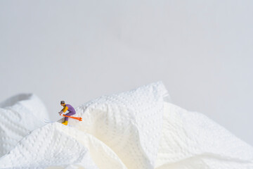 Skiers in action, white snow landscape, miniature figures scene, winter sports