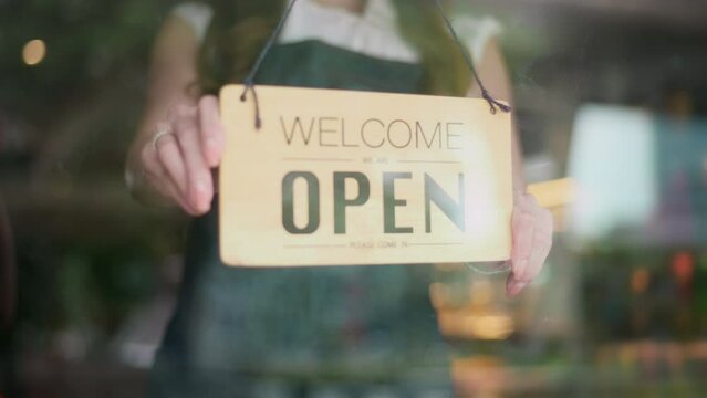 Woman entrepreneur with Open sign in cafe shop , small business concept