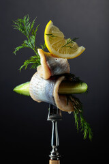 Herring fillet in oil with lemon, cucumber, and dill.