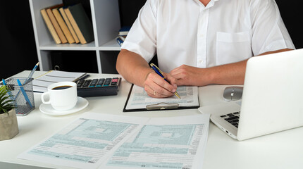 man completing tax form 1040. Tax time