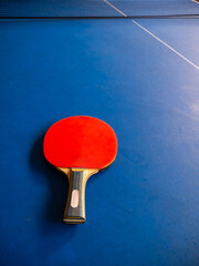 Table tennis racket and blue table