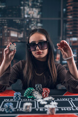 Pretty female playear play in Texas Hold'em poker and win  lot of chips, poker room at casino