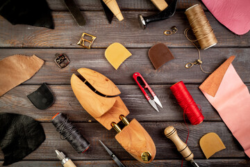 Cobber leather tools in workshop, hand craft. handbag or shoe manufacturing industry - obrazy, fototapety, plakaty
