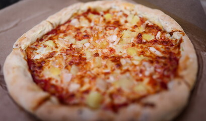 Close-up of small homemade round shaped pizza. Hot fresh yummy salami double cheese parmesan mozzarella and tomatoes. Traditional italian food. Fastfood and lunch concept