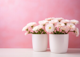 Pink flowers are arranged on the table in vases