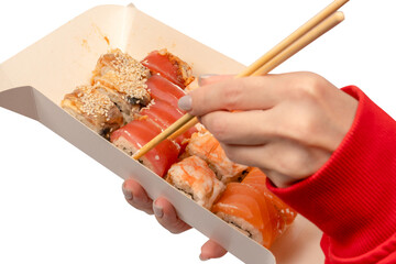 Food delivery. A box with sushi rolls in woman hands isolated.