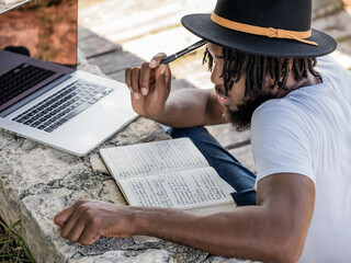 Male podcaster thinking over project in park