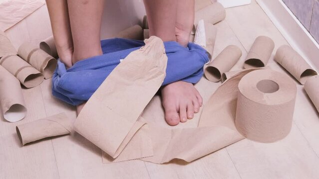 child, boy sitting on the toilet with toilet paper and suffering from constipation, diarrhea, stomach ache or cramps, Hygiene, health care concept