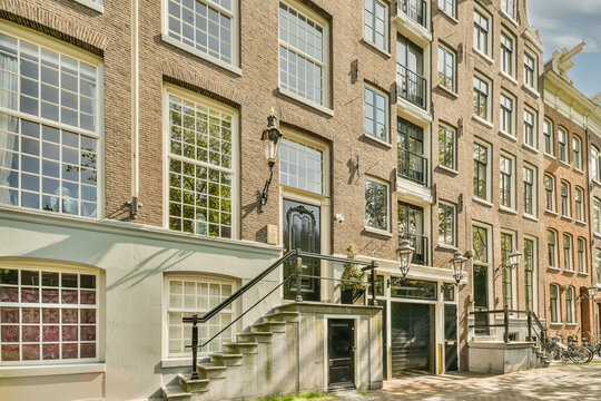 Classic Amsterdam Architecture with Tree-lined Street