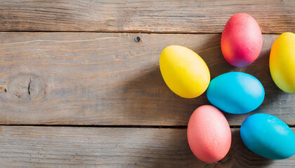 Fototapeta na wymiar Colorful painted Easter eggs on wooden background, copy space