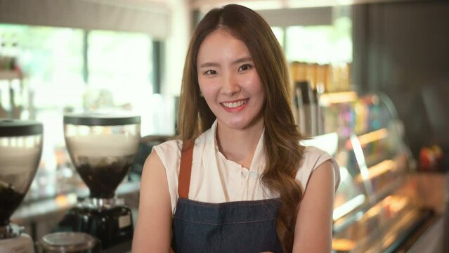 An Asian woman entrepreneur or barista working in modern coffee shop , concept small business
