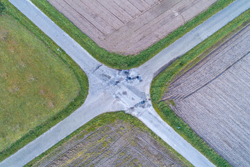 aerial view of the four-lane asphalt crossing between agricultural fields, crossroads of roads