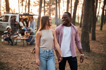 Obraz premium Happy black man with woman. Group of friends are together in the forest