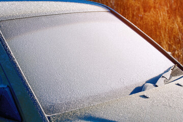 Windshield covered with ice, frozen glass and wiper. Car window under layer of ice. Frost on car...